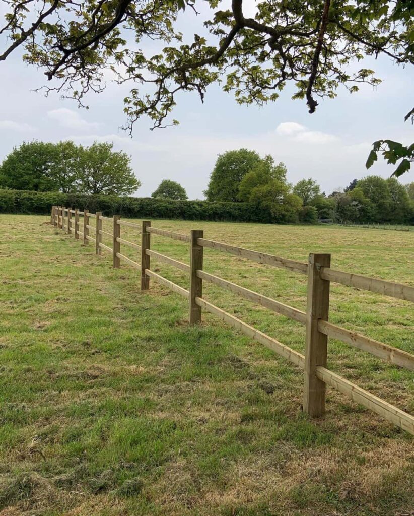 This is a photo of a post and rail fence installed in a field by Fast Fix Fencing Dereham